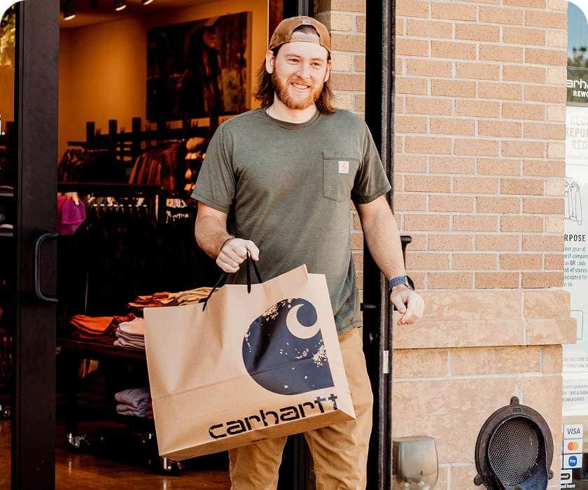 Nick happily leaving a Carhartt store with new gear.