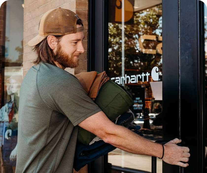 Nick opening the door to a Carhartt store.